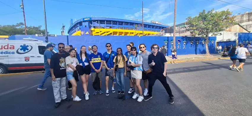 A group of Adelphi University students volunteering abroad with IVHQ, posing outside the Boca Juniors “Bombonera” Stadium in Buenos Aires, Argentina.